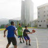 A basketball court out in the open for students to practice ball-shooting